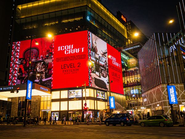Mall exterior facade covered in large digital advertising screens